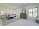 Bright bedroom with a metal bed frame, dresser, and large windows at 10755 E Cholla Ln, Scottsdale, AZ 85259