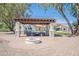 Firepit area with pergola and seating in the backyard at 10755 E Cholla Ln, Scottsdale, AZ 85259