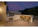 Outdoor kitchen with grill and seating area at 10755 E Cholla Ln, Scottsdale, AZ 85259