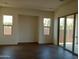 Bright and airy living room with tile flooring and sliding glass doors leading to the backyard at 21042 E Camina Buena Vis, Queen Creek, AZ 85142