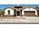 Two-story home with a two-car garage and desert landscaping at 21042 E Camina Buena Vis, Queen Creek, AZ 85142