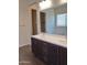 Double vanity bathroom with modern dark cabinets and a soaking tub at 21042 E Camina Buena Vis, Queen Creek, AZ 85142