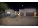 Night view of a modern home with two-car garage at 7056 E Mighty Saguaro Way, Scottsdale, AZ 85266