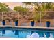 Scenic view of the pool area with decorative fence and potted plants at 7056 E Mighty Saguaro Way, Scottsdale, AZ 85266