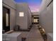 Pathway between stucco walls leads to a contemporary home's entry at 7056 E Mighty Saguaro Way, Scottsdale, AZ 85266