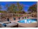 Peaceful backyard pool and patio area with string lights and lounge chairs at 7056 E Mighty Saguaro Way, Scottsdale, AZ 85266