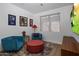 Relaxing sitting area with comfortable armchairs, ottoman, and a large TV at 7056 E Mighty Saguaro Way, Scottsdale, AZ 85266
