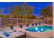Evening view of the sparkling pool and patio with lounge chairs at 7056 E Mighty Saguaro Way, Scottsdale, AZ 85266