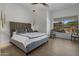 Spacious main bedroom with plush bedding and backyard access at 7056 E Mighty Saguaro Way, Scottsdale, AZ 85266