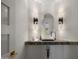 Stylish powder room with unique sink and modern light fixtures at 7056 E Mighty Saguaro Way, Scottsdale, AZ 85266