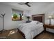 Bright bedroom with wood flooring, large window, and a comfortable bed at 7056 E Mighty Saguaro Way, Scottsdale, AZ 85266