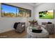 Relaxing sitting area with large window and flat-screen TV at 7056 E Mighty Saguaro Way, Scottsdale, AZ 85266