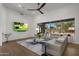 Spacious living room with large sectional sofa and backyard view at 7056 E Mighty Saguaro Way, Scottsdale, AZ 85266
