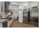 Modern kitchen with stainless steel appliances and white cabinetry at 7056 E Mighty Saguaro Way, Scottsdale, AZ 85266