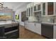 Modern kitchen with white cabinets, marble countertops, and stainless steel appliances at 7056 E Mighty Saguaro Way, Scottsdale, AZ 85266