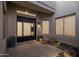 A courtyard entry features a modern front door and potted plants at 7056 E Mighty Saguaro Way, Scottsdale, AZ 85266