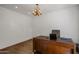 Spacious home office with large desk, chandelier and wood flooring at 7056 E Mighty Saguaro Way, Scottsdale, AZ 85266