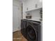 Laundry room with modern LG washer and dryer, and ample storage at 7056 E Mighty Saguaro Way, Scottsdale, AZ 85266