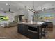 Modern kitchen with large island, stainless steel appliances, and breakfast bar at 7056 E Mighty Saguaro Way, Scottsdale, AZ 85266