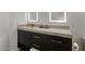 Modern bathroom with dark vanity, quartz countertop and a sleek design at 7056 E Mighty Saguaro Way, Scottsdale, AZ 85266