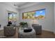Bright sitting area with comfortable chairs and a view of the backyard at 7056 E Mighty Saguaro Way, Scottsdale, AZ 85266