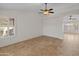 Open and airy living room with tile floors and a view to another room at 17613 N Kimberly Way, Surprise, AZ 85374