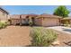 Single-story home with a two-car garage and desert landscaping at 17613 N Kimberly Way, Surprise, AZ 85374