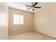 Well-lit bedroom featuring tile floors and a ceiling fan at 864 E Riviera Pl, Chandler, AZ 85249