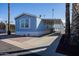 Charming light blue manufactured home with covered carport at 2601 E Allred Ave # Br24, Mesa, AZ 85204