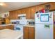 Kitchen boasts wood cabinets and white appliances at 2601 E Allred Ave # Br24, Mesa, AZ 85204