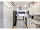 Clean and spacious kitchen with white cabinets and gray tile floors at 5013 E Mesquite Wood Ct, Phoenix, AZ 85044