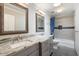 Updated bathroom with double vanity, granite countertop, and tub shower combo at 6120 N 31St Ct, Phoenix, AZ 85016