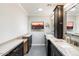 Elegant bathroom with double sinks, granite countertops, and large mirror at 6120 N 31St Ct, Phoenix, AZ 85016