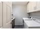 Laundry room with washer, dryer, and ample cabinetry at 6120 N 31St Ct, Phoenix, AZ 85016