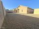 Backyard with gravel and a storage shed, viewed from the opposite corner at 1317 W Santa Gertrudis Trl, San Tan Valley, AZ 85143