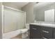 Bathroom with tub, shower, and dark vanity at 7221 W Globe Ave, Phoenix, AZ 85043