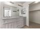 Bathroom with double vanity, granite countertop, and gray cabinets at 7221 W Globe Ave, Phoenix, AZ 85043
