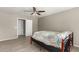 Bedroom with ceiling fan, wood-framed bed, and tile flooring at 7221 W Globe Ave, Phoenix, AZ 85043