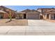 Single-story house with a two-car garage and desert landscaping at 7221 W Globe Ave, Phoenix, AZ 85043
