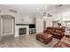 Living room with fireplace, leather furniture, and ceiling fan at 7221 W Globe Ave, Phoenix, AZ 85043