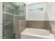 Bathroom with walk-in shower, bathtub, and tile flooring at 7221 W Globe Ave, Phoenix, AZ 85043