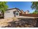 Backyard view of home with gravel and a partial fence at 7221 W Globe Ave, Phoenix, AZ 85043