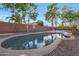 Inviting kidney-shaped pool surrounded by a gravel patio at 16403 W Baden Ave, Goodyear, AZ 85338