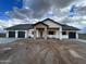 Modern two-story home with stone accents and a three-car garage at 0 W Pima Rd, Maricopa, AZ 85139