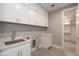 Laundry room with white cabinets and built-in sink at 0 W Pima Rd, Maricopa, AZ 85139