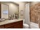 Bathroom with granite vanity, tile shower, and a linen closet at 127 E Sabrosa Dr, New River, AZ 85087