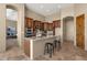 Island kitchen with granite countertops and wood cabinets at 127 E Sabrosa Dr, New River, AZ 85087