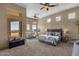 Spacious main bedroom with large windows, plush carpet, and seating area at 127 E Sabrosa Dr, New River, AZ 85087
