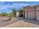 House exterior with a two-car garage and landscaped yard at 127 E Sabrosa Dr, New River, AZ 85087