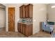 Butlers pantry with wood cabinets and granite countertop at 127 E Sabrosa Dr, New River, AZ 85087